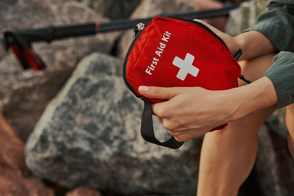 first-aid-kit-in-hands-of-a-hiker-ten-essentials-hiking-beginner-.jpg