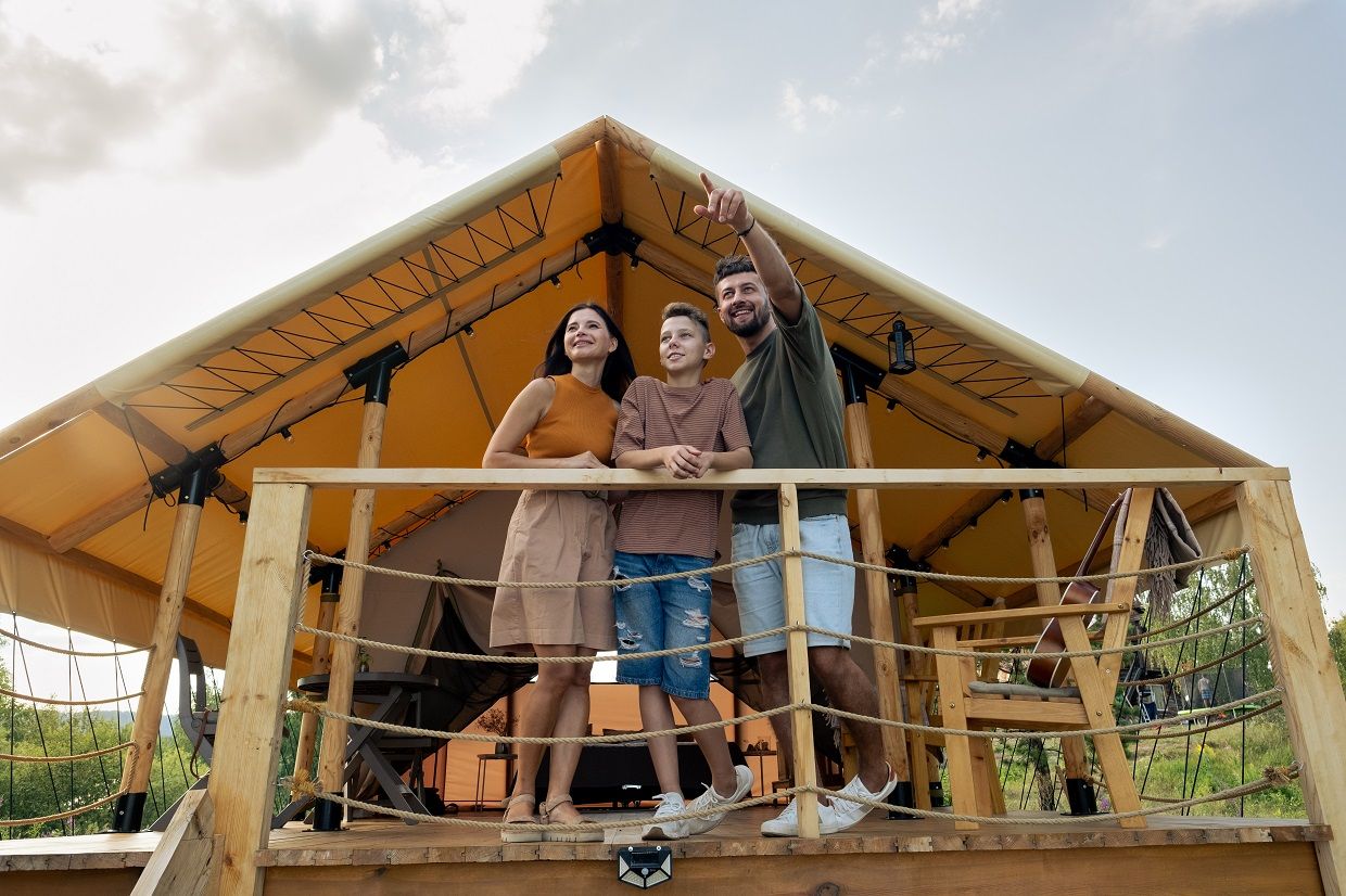 happy-family-standing-by-glamping-house-in-natural-2021-09-24-03-46-37-utc.JPG