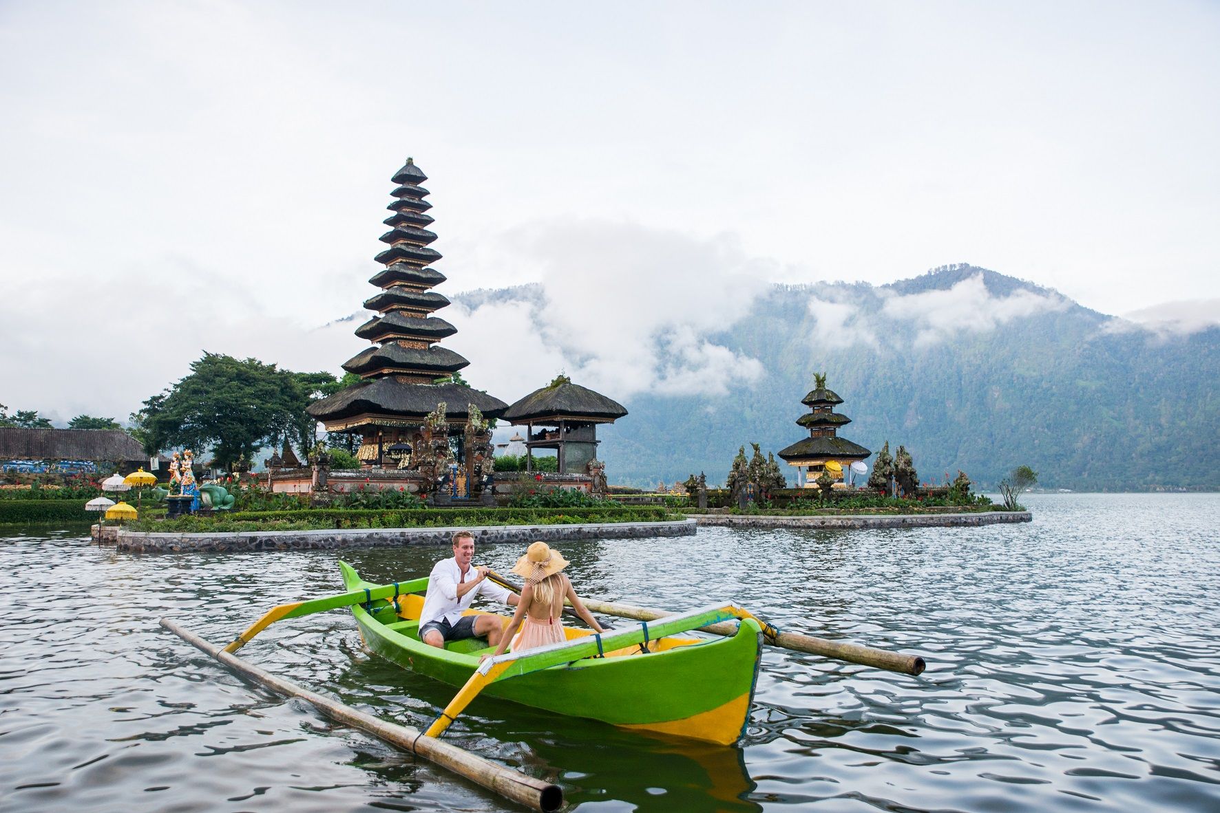 young-couple-paddling-on-a-wooden-boat-at-pura-ulu-2021-09-01-17-17-43-utc.jpg