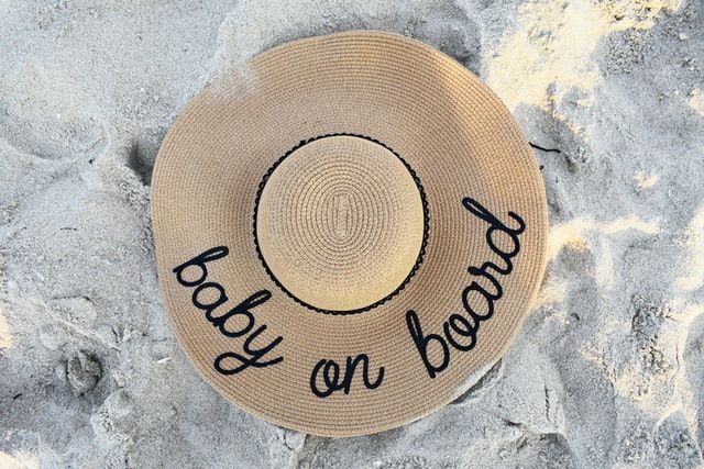 beach-hat-on-beach-sand-essential-things-to-bring-on-beach-vacation.jpg