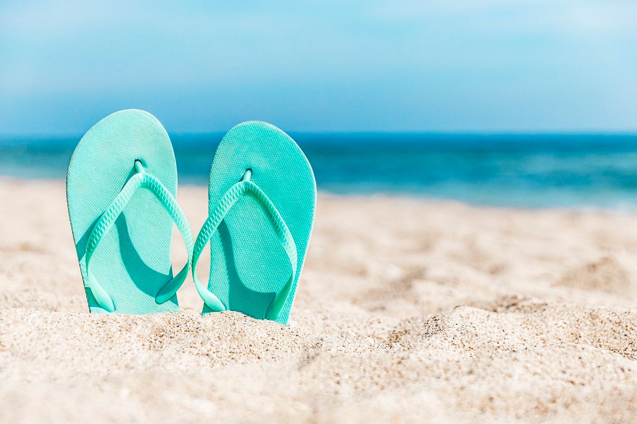 flip-flops-stuck-in-the-sand-on-a-sandy-beach-by-t-2021-12-21-19-57-53-utc.jpg
